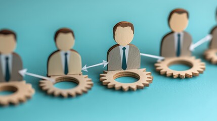 A visual representation of teamwork and collaboration, featuring wooden figures connected by gears, symbolizing interconnected roles in a professional setting.