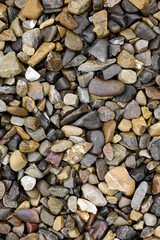 Natural stones background with mixed textures and colors.