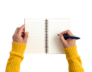 Person in yellow sweater writing in open notebook with blue pen, top-down view