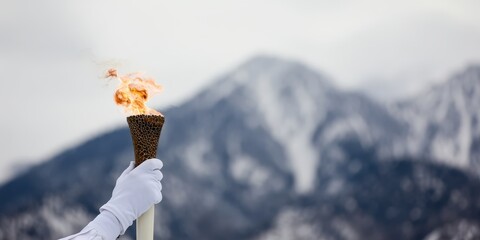Olympic torch relay in snowy mountains for winter games
