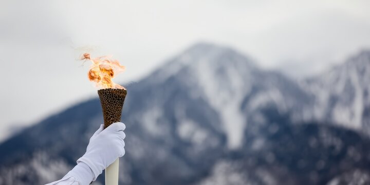 Olympic torch relay in snowy mountains for winter games