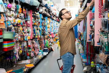 Adult man choosing pet supplies in a retail store
