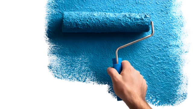 Close-up of hand painting a wall with blue paint roller for home renovation