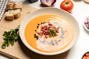 Cold tomato soup, salmorejo, served with iberico jam. Spanish traditional food.