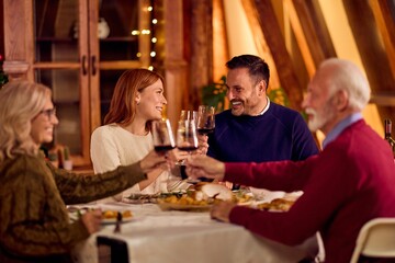 Friends And Family Toast At Cozy Dinner Table During New Year Celebration