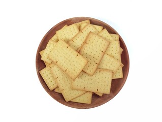 Pile of square biscuits crackers on plate isolated on white background. Flat lay 