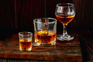Strong alcohol drink. Whisky in glass, Whisky, bourbon or cognac. Hard strong alcoholic drinkIn various glass forms