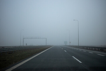 Driving in foggy weather on the highway. Driving in autumn and winter weather.