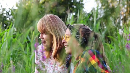Happy Mother and Teenage Daughter. Smiling in a Summer Field. Summer Nature. Mother and Teenage Daughter in a Grassy Field. relationship between a mother and her growing daughter