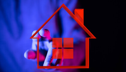 Conceptual image of a hand holding a house symbol. Represents real estate, homeownership, dream,...