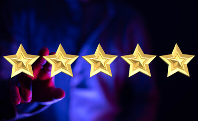 A person's hand with five golden stars, representing positive feedback, reviews, or success. Great for concepts like ranking, rating, achievemen