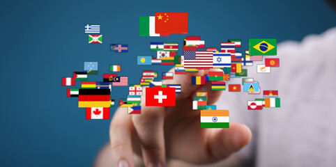 A hand points towards a collection of miniature flags, symbolizing international relations, globalization, and the interconnectedness of nations