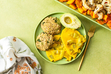 Enjoy a vibrant breakfast featuring scrambled eggs with rhubarb, fluffy quinoa pancakes, creamy avocado drizzled with olive oil, roasted vegetables, and a refreshing fresh salad