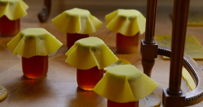 Natural farm honey in glass jars with honeycombs. Organic product concept, sweetness, health and countryside tradition.