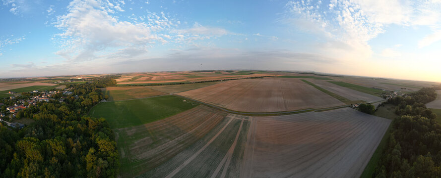 Bergnicourt, Rethel, Ardennes, Grand-Est, France, August, 28th, 2025, A stunning aerial view showcases vast expanses of farmland featuring neatly plowed fields beneath beautiful clouds