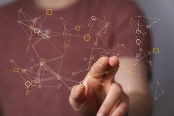 Close-up of a hand interacting with a digital network illustration. Represents technology, data, connections, and modern concepts like AI. Great