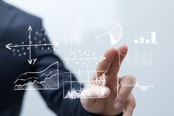 A businessperson interacting with projected data visualizations, symbolizing innovation, technology, and market analysis. Highlighting finance,