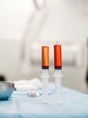 Syringes filled with resorbable microspheres are prepared in a clinical setting, designed for targeted treatment of liver tumors through controlled drug release