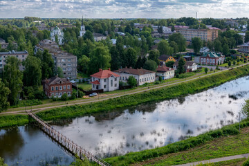 Obraz premium KASHIN, TVER Region, RUSSIA - July 07, 2025: Wooden pedestrian bridge over the Kashinka River