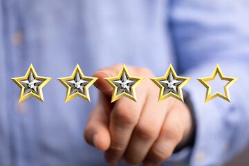 A hand interacting with a digital representation of gold stars, indicating customer service...