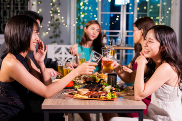  Friends having fun clinking glasses with beer