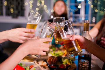 Friends having fun clinking glasses with beer