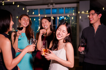 A group of beautiful girls at a company party, drinking, celebrating New Year, club party with friends.