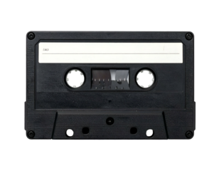 A classic black audio cassette tape isolated against a stark black background