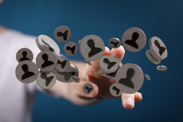 Hand reaching for 3D people icons, illustrating HR, social network, teamwork and leadership...