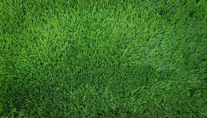 Fototapeta premium Overhead Perspective Of Synthetic Green Grass Texture And Surface Decorative Artificial Turf Suitable For Gardens Sports Fields And Golf Greens Green Background And Wallpaper With Space For Text
