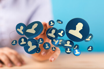 Concept of social media management and networking represented by 3D profile icons in connection with a hand on blue background.