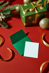 Flat lay scene with green and white cards, ribbons, and baubles. Perfect for Christmas greeting...