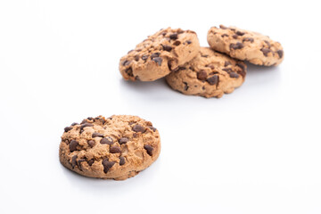 Chocolate chip cookie on a white background. In the background, a group of blurred cookies.