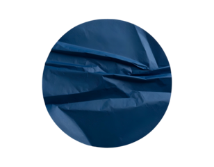 Close-up of crumpled, navy blue fabric inside a dark circular frame with textured shadows
