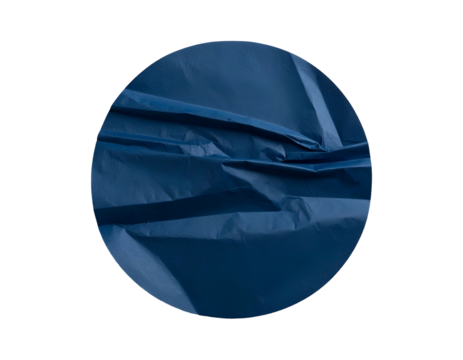 Close-up of crumpled, navy blue fabric inside a dark circular frame with textured shadows - Powered by Adobe
