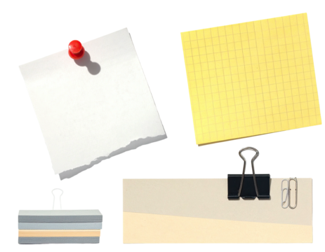 Assorted stationary items isolated on black; include sticky notes, papers, and a paperclip