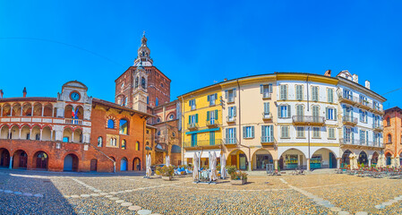 Panoramic view on medieval buildings of Piazza della Vittorio with high dome of Cathedral on background, Pavia, Italy
