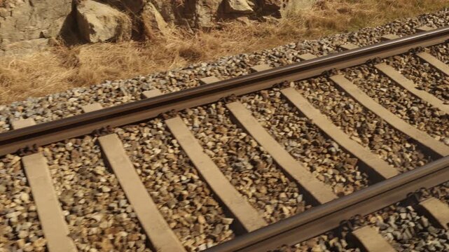 Train moving along railway tracks with motion blur, symbolizing speed, travel, and transportation.