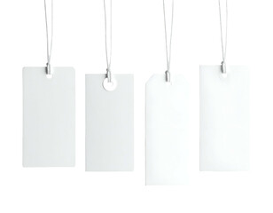 Four plain, white rectangular tags hanging from strings against a stark black background