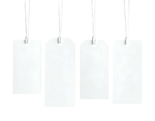Four blank, rectangular white labels suspended from strings, isolated on a black background