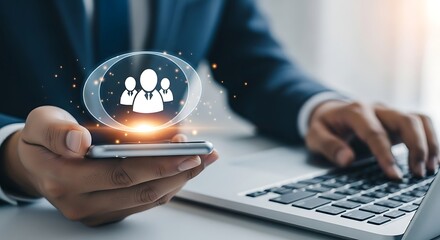 Businessman uses smartphone and laptop to manage human resources and digital connections