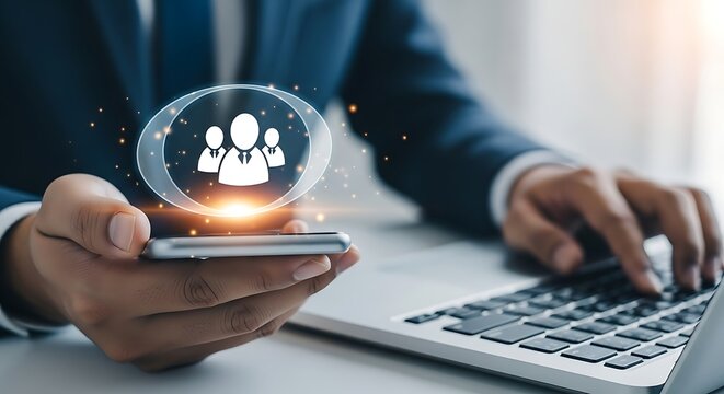 Businessman uses smartphone and laptop to manage human resources and digital connections