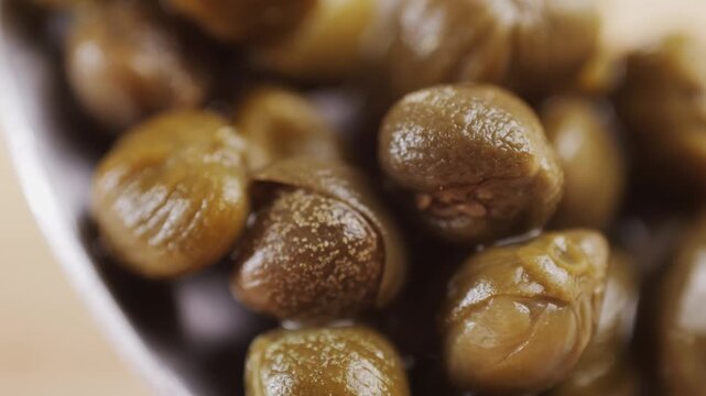 Pickled capers spanish food. Marinated buds of caper bush. Mediterranean cuisine ingredient. Organic spices and seasonings for meat, fish and vegetables, macro shot. Top view.