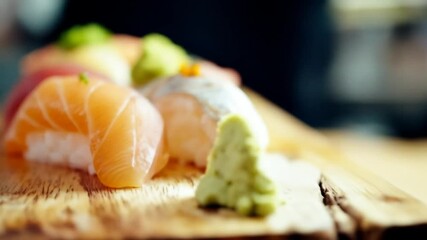 Close up of delicious sushi arrangement on wooden board for food concept