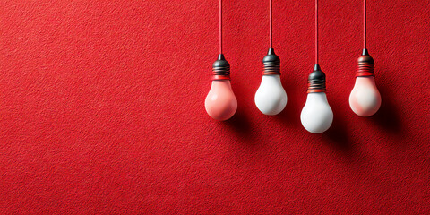 Row of Hanging Red and White Light Bulbs on Textured Wall