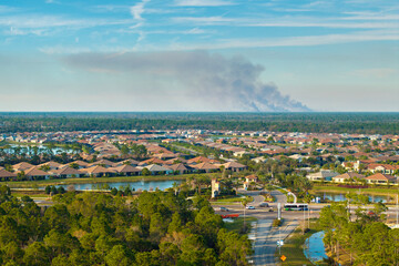 Air pollution with toxic smoke from prescribed forest fire close to rural neighborhood in Florida, USA