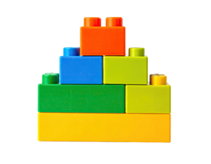 A pyramid structure is built with colorful, plastic interlocking construction bricks