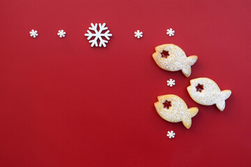 Christmas composition with linzer cookie in a shape of fish and snowflakes, copy space for text