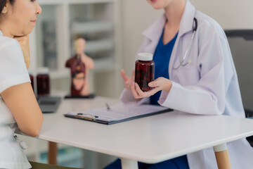 Fototapeta premium Health Consultant Medical Concept Doctors consult with patients, discuss symptoms of disease and recommend treatments, present the results in reports and prescriptions.