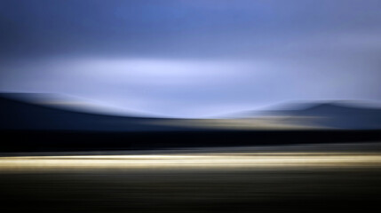 Abstract landscape with horizontal motion blur and streaking golden light, creating a mysterious and atmospheric impression